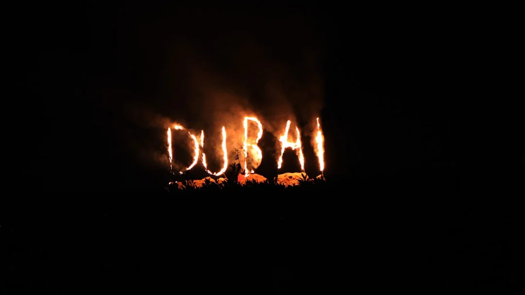 A blurry photo of the word dubai lit up in the dark
