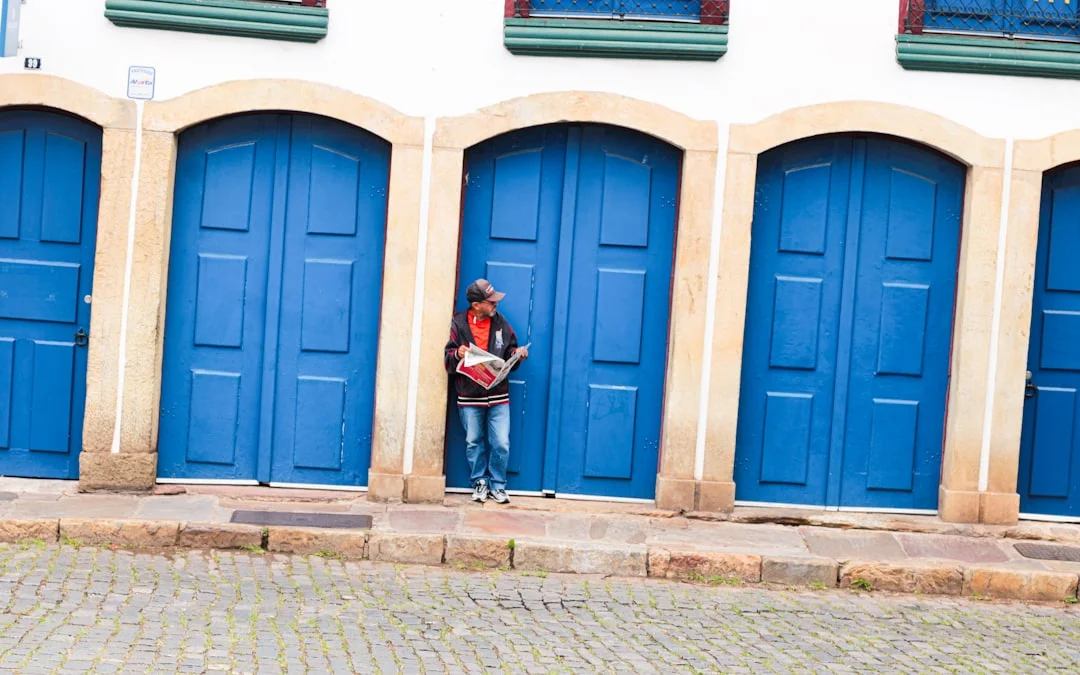 Person standing in front of bright blue doors