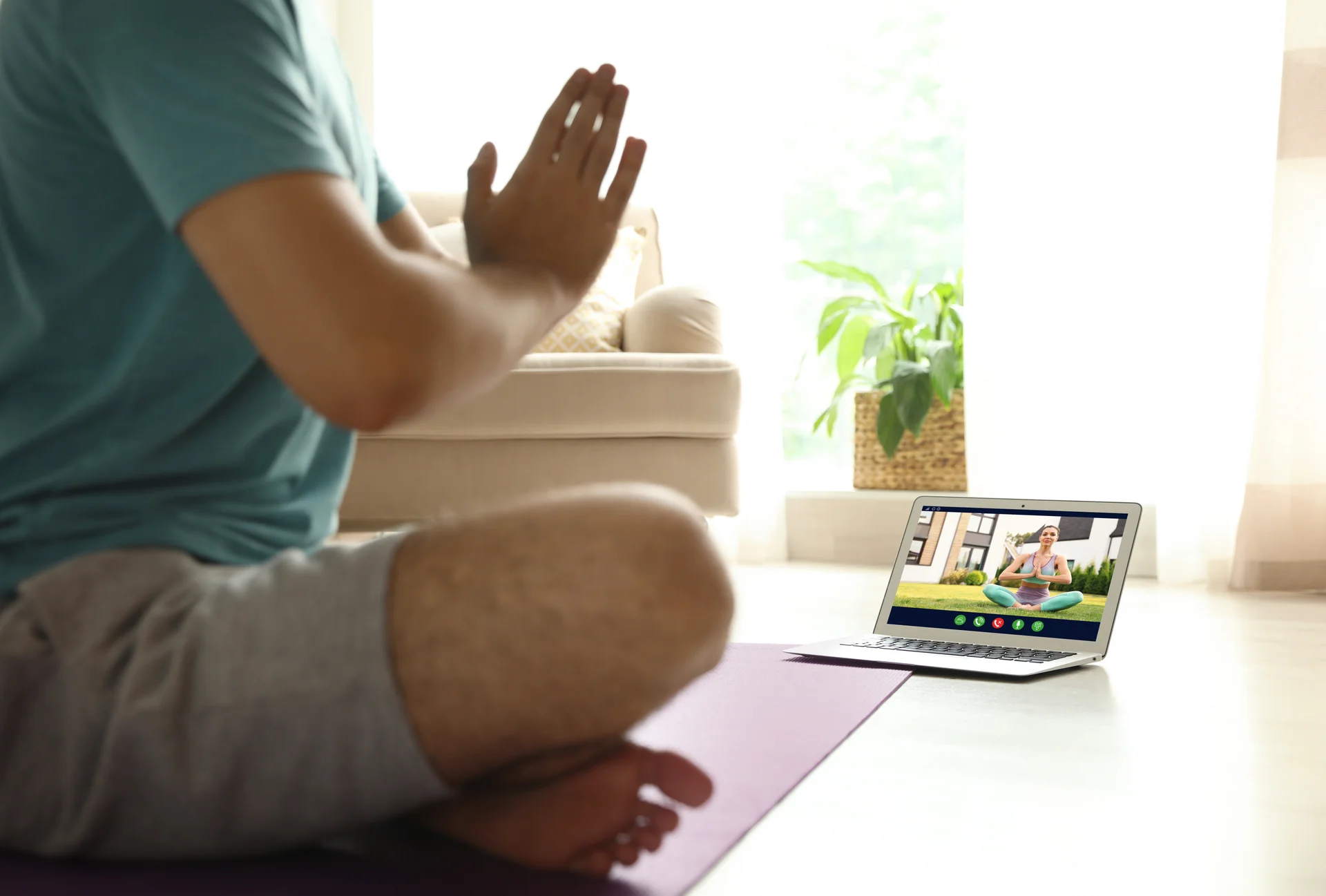Distance yoga course during coronavirus pandemic Man having online practice with instructor via laptop at home closeup