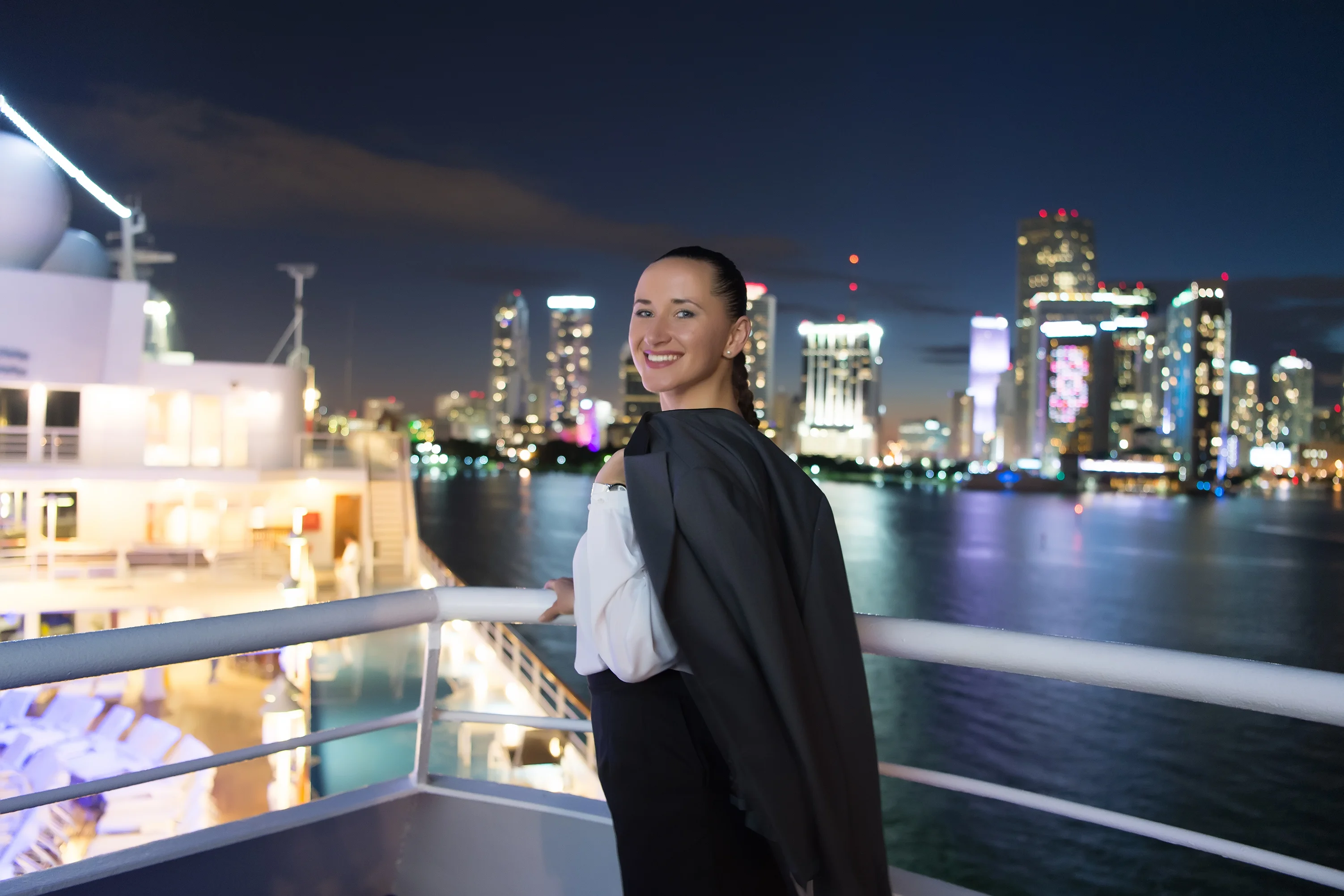 Business woman stand on ship board at night in miami usa Sensual woman in suit jacket on city