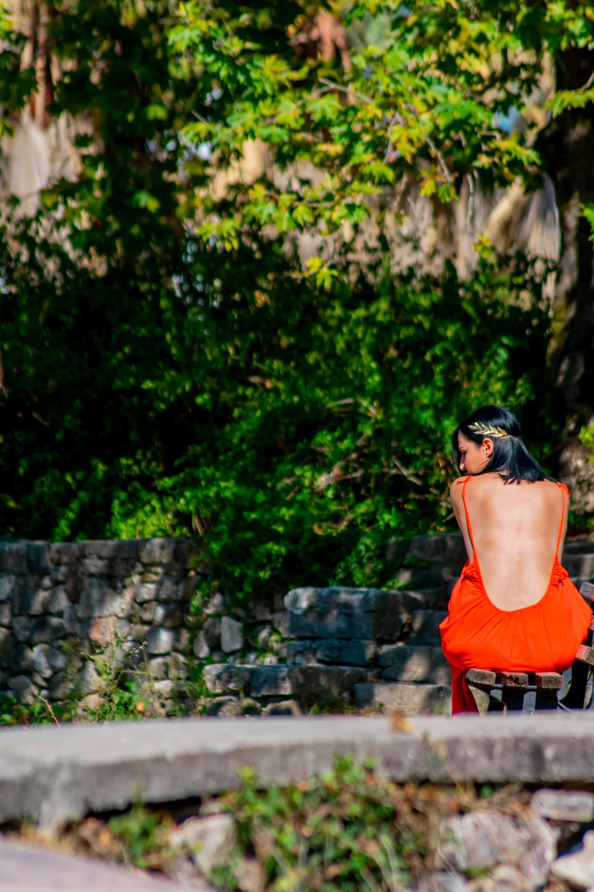 Rear view of woman sitting at park
