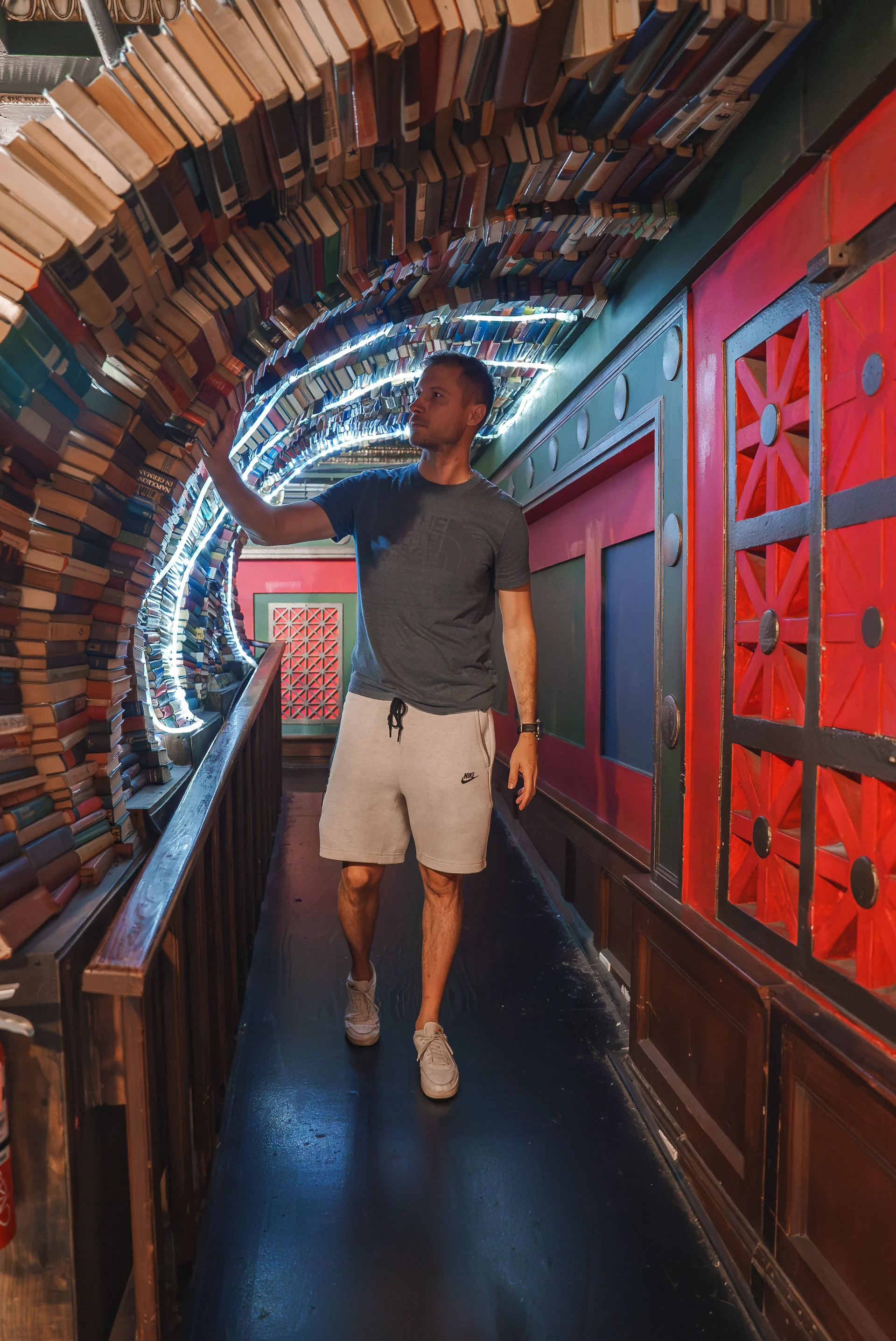 Man Walking Through Book Tunnel at The Last Bookstore Los Angeles