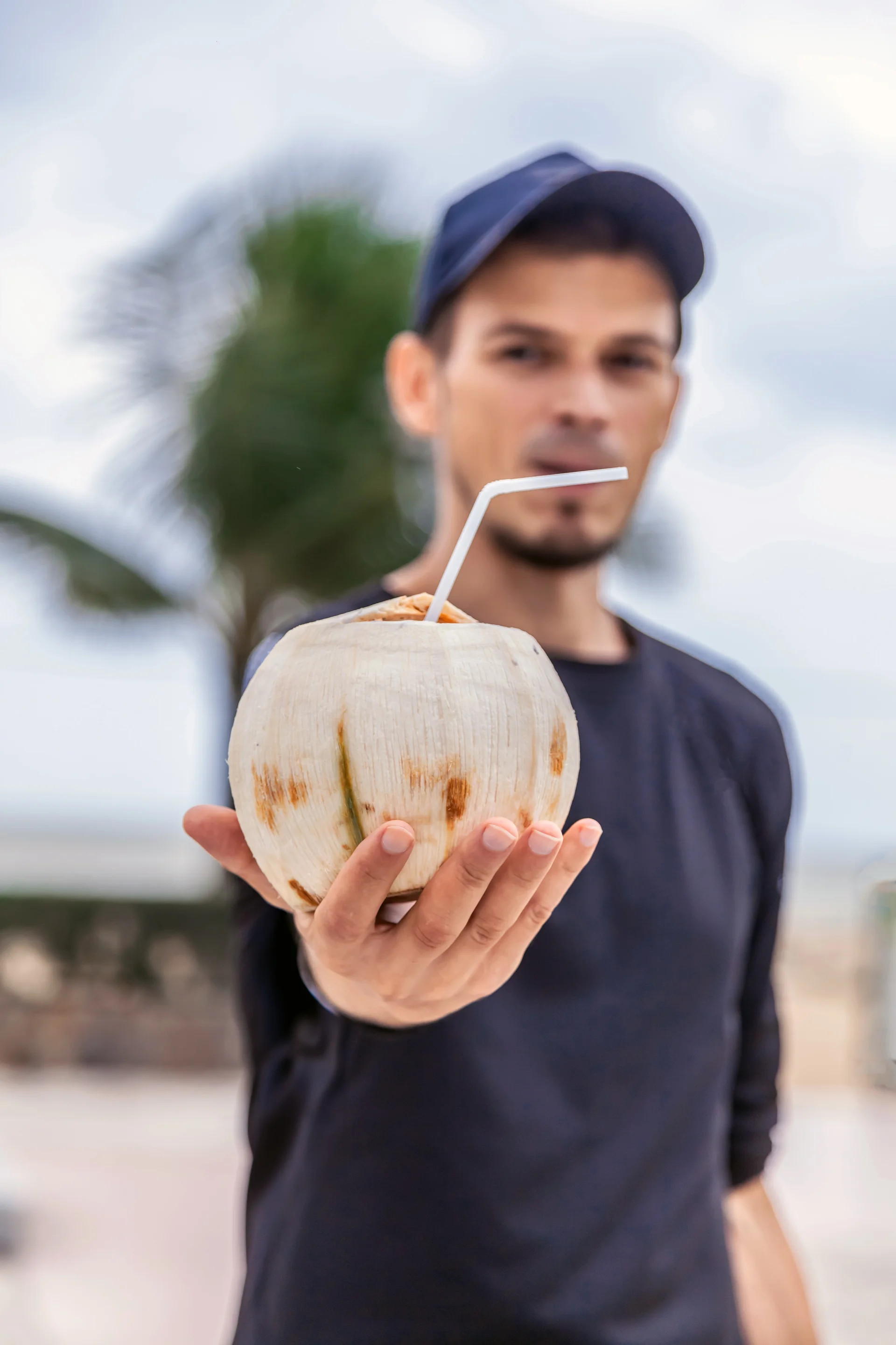 Young attractive man with coconut fruits